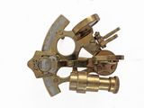 a very old brass sexet on a white background