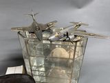 a small model of a plane sitting on top of a glass container