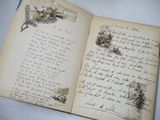 an old book with writing on it sitting on a table