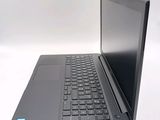 a laptop computer sitting on a table with a keyboard