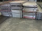 a pile of steel bars stacked up in a warehouse