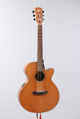 a close up of a guitar on a stand against a white background