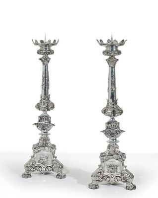 pair of antique silver candlesticks with floral designs
