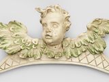a statue of a man with wings on a shelf