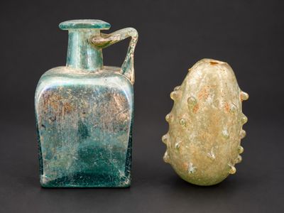 two glass vases sitting next to each other on a table