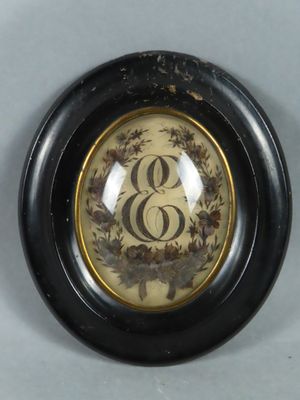 a picture of a picture of a monogram in a black frame