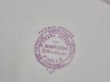 a close up of a plate with a stamp on it