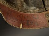 a close up of a brown hat with a leather band