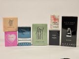 five different types of perfumes on a white surface