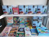 many children ' s books on a shelf in a room