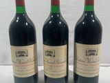 three bottles of wine sitting on top of a table next to each other
