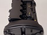 a close up of a black engine cover on a white table