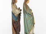 two figurines of jesus and mary standing next to each other