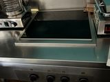 an image of a commercial kitchen with a stove and a toaster