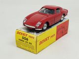 a red toy car sitting on top of a box
