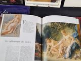 a lot of books on the table with pictures on them