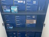 a blue bookcase with many boxes on it