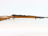un fusil sur une surface blanche avec un fond blanc