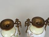 two vases that are sitting on a table