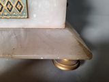 a white marble table with a gold and blue design on it