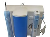 an image of a toothbrush and toothpaste dispenser