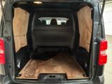 the back of a van with a bed in the back of it