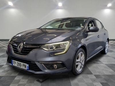 the grey car is parked on a checkered floor in a garage