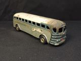 a toy bus that is sitting on a black surface