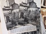 a pile of old photos on a table in a room