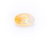 a yellow oplite gems on a white background