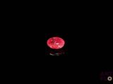 a red diamond on a black surface in the dark