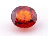 a close up of a red diamond on a white surface