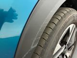 a close up of a car ' s tire with a shadow on it