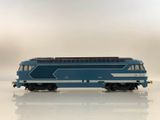 a blue and white train on a white surface