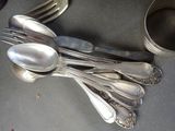 a lot of silver spoons and spoon spoons on the table