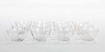 six clear glass cups and saucers sitting on a white surface
