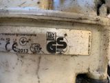 a close up of a dirty motorcycle with a sticker on it