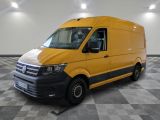 the yellow van is parked on a checkered floor in the garage