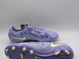 a pair of purple and yellow soccer shoes on a white background
