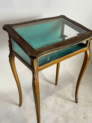 a small table with a glass top on a white surface