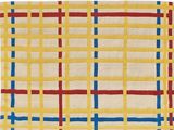 a yellow rug with blue, red and white squares on it
