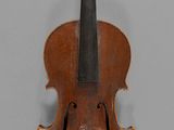 a close up of a violin on a gray surface