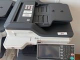 two printers sitting on top of each other on the floor