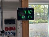 a digital clock on the wall in a garage