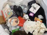 a white trash can filled with items and a cat
