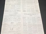 two pages of a newspaper on a table with a black background