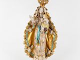 a statue of the virgin of guadalupe with a crown on her head