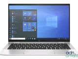 the laptop is open on a white surface with windows on the screen