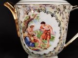 a tea pot with a painting on the side of it