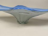 a blue glass bowl sitting on a white surface